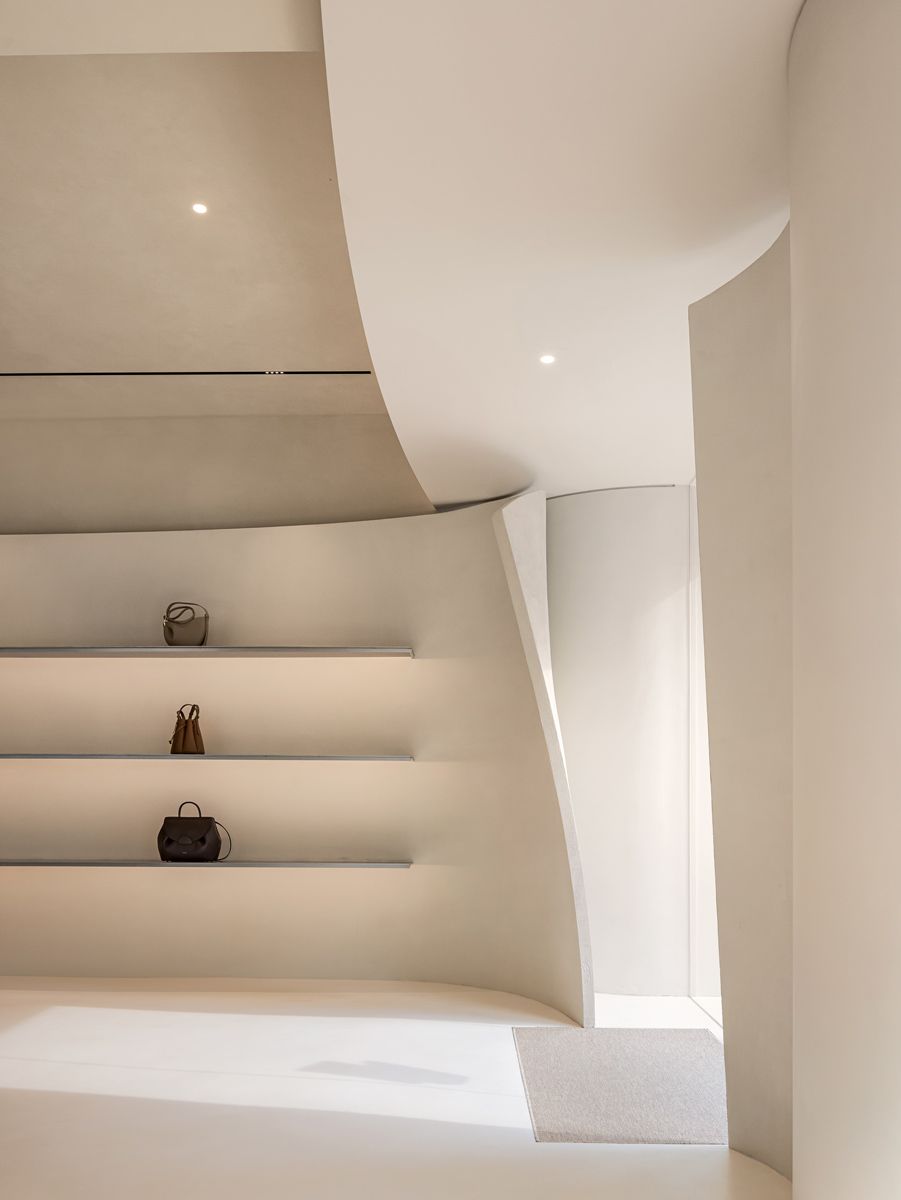 The Seoul store building’s wavy lines and soft, textured beige stone façade evoke a feminine sensibility