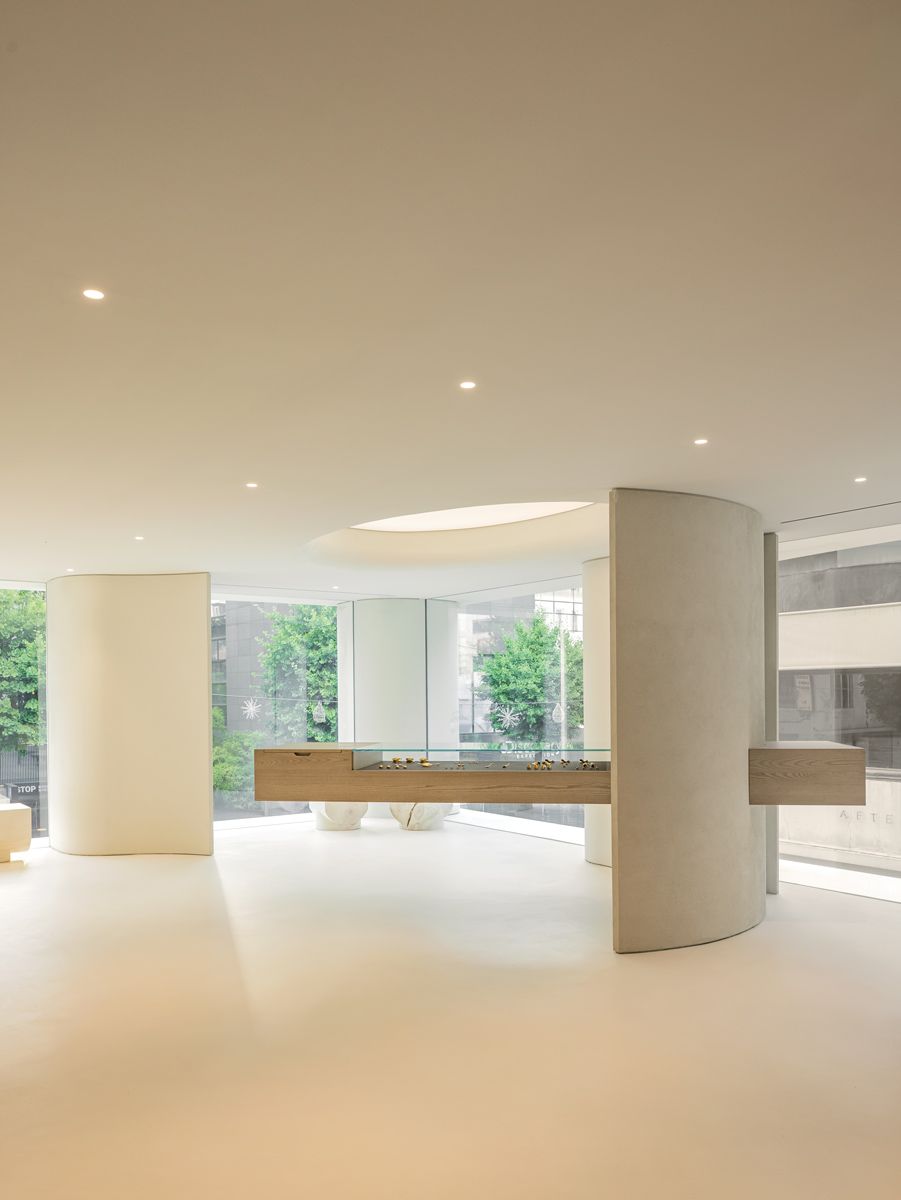 This cantilevered counter appears as if floating, softening the brutalist interior