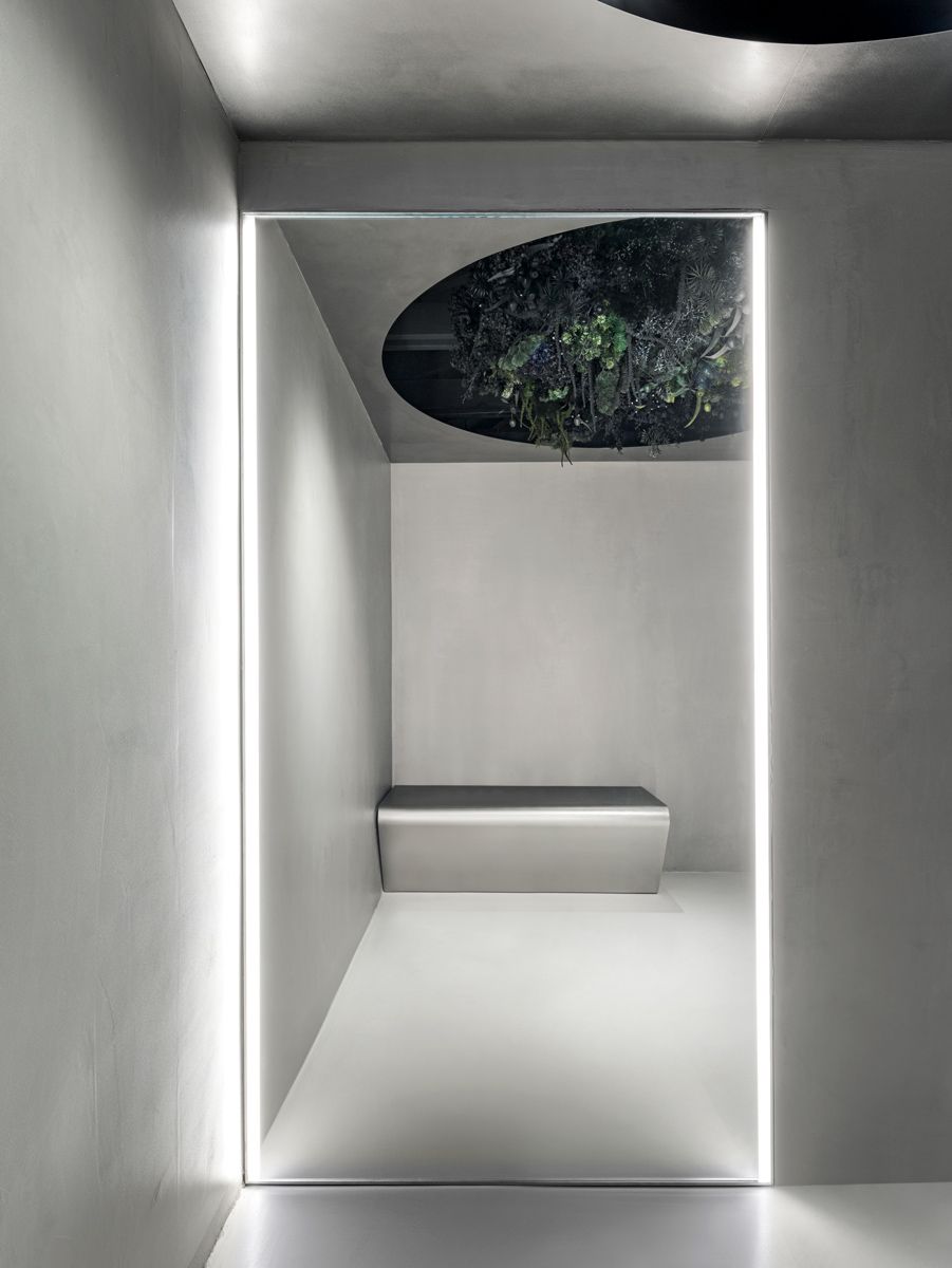 Greenery embedded in the ceiling softens the futuristic look of the boutique