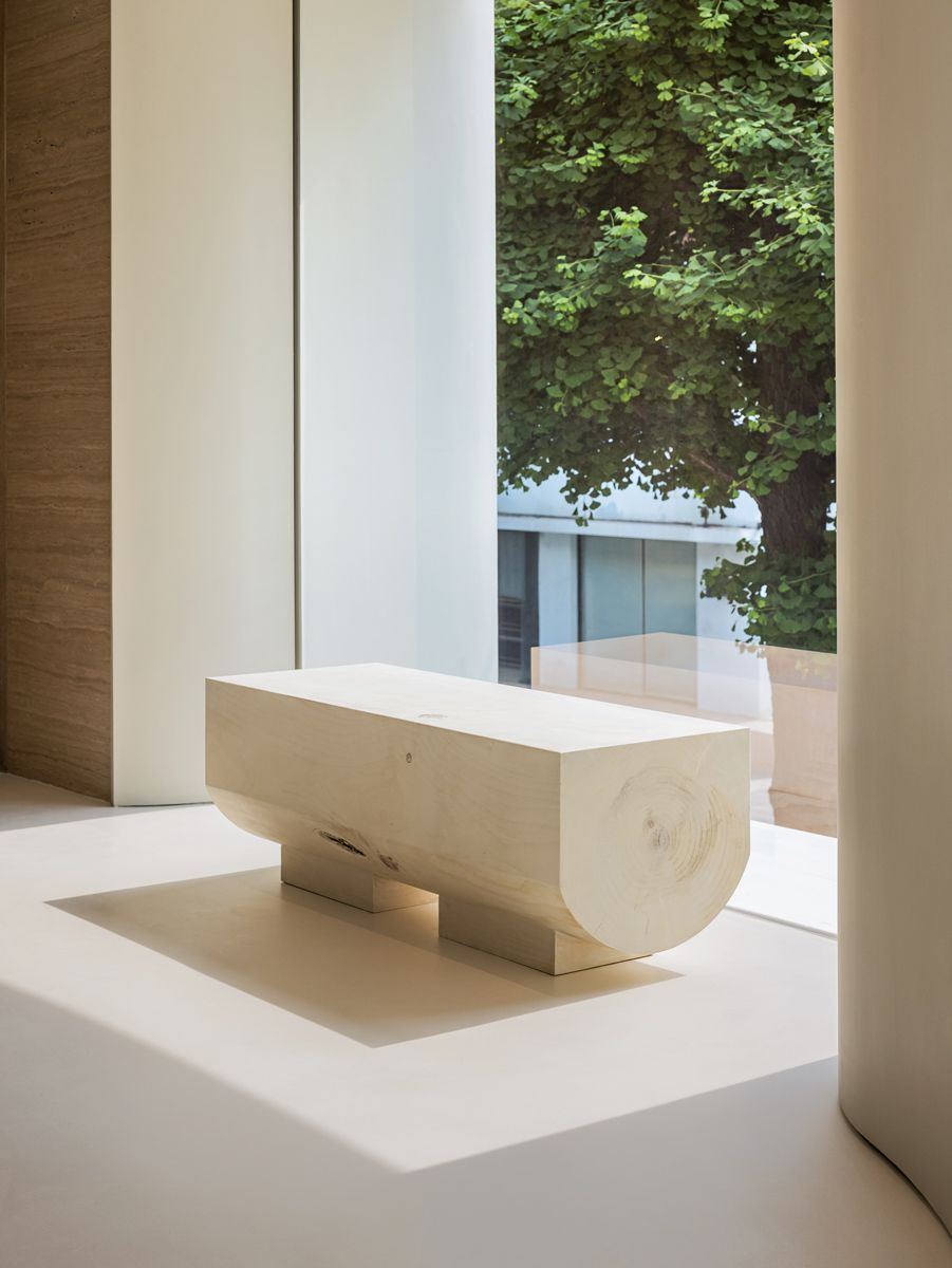 A solid wood bench invites shoppers to rest their weary legs and enjoy the view