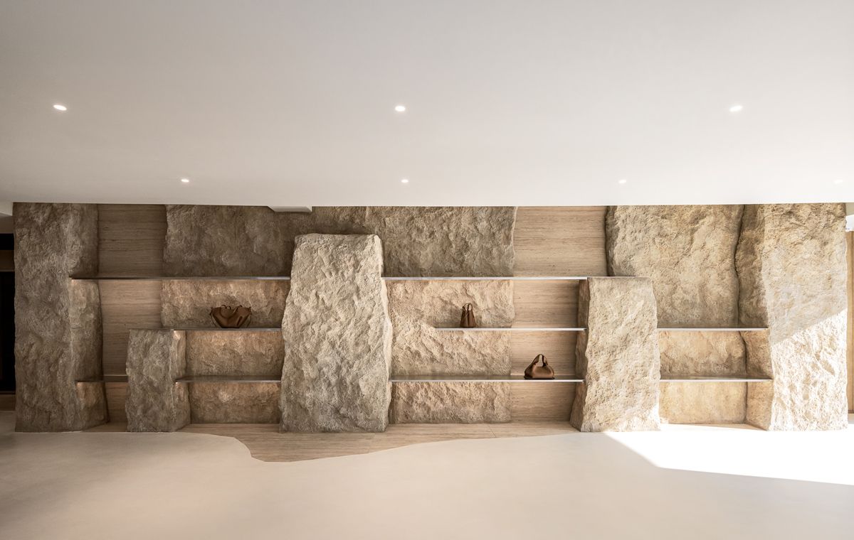 The interior juxtaposes rough textured with delicate, thin lines that beautifully showcases the leather bags