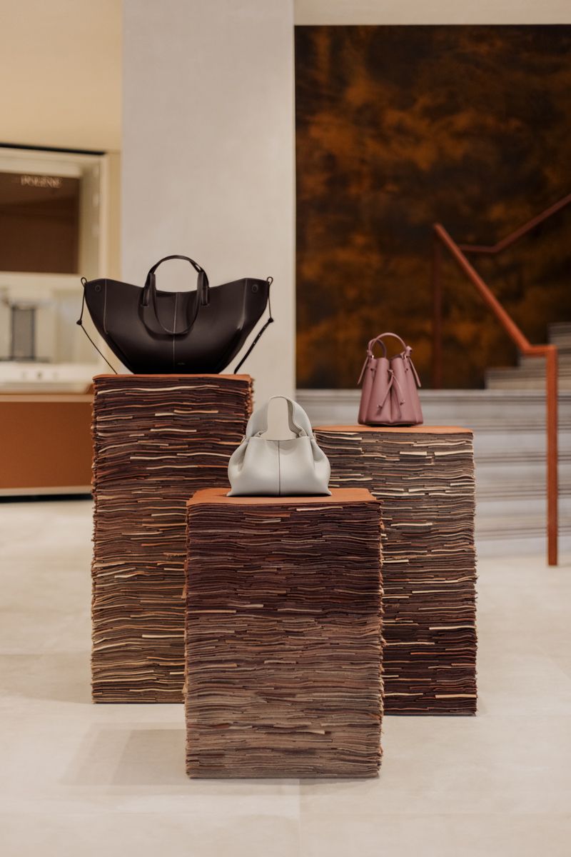 On the ground floor, bags are displayed on pedestals made of leather