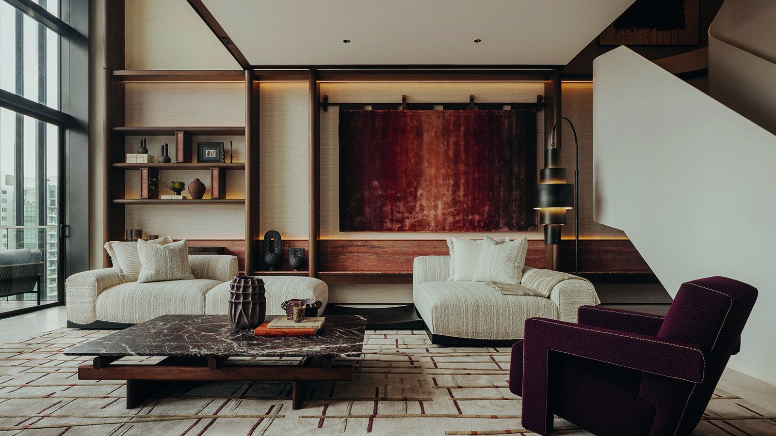 The home’s living room is enriched by shapely forms and deep burgundy accents