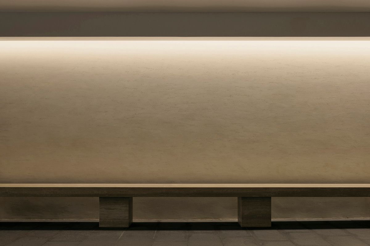 The travertine bench in the Bukit Timah landed home's basement is a nod to legacy of the iconic Barcelona Pavilion