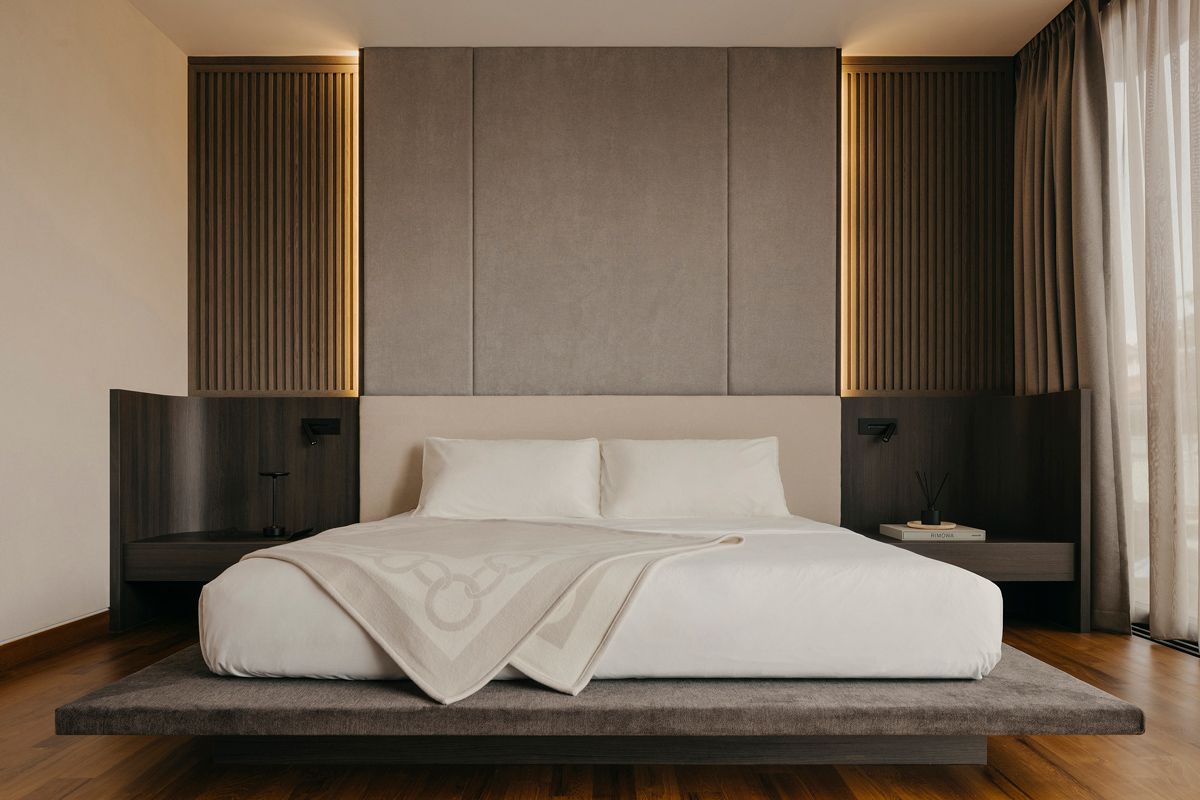 The mattress is placed on a low-slung platform in handsome dark finish