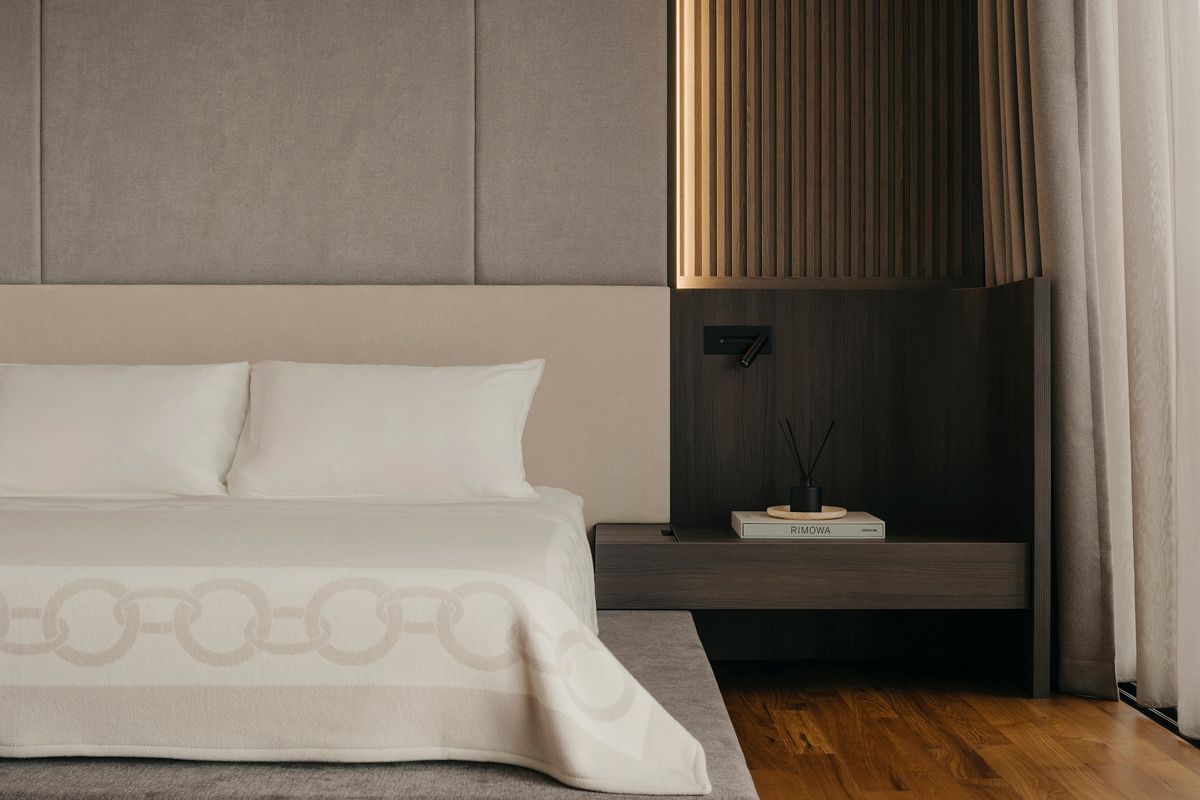 The design details of the interior elements, like the bed side tables, features curves that are echoed throughout the home