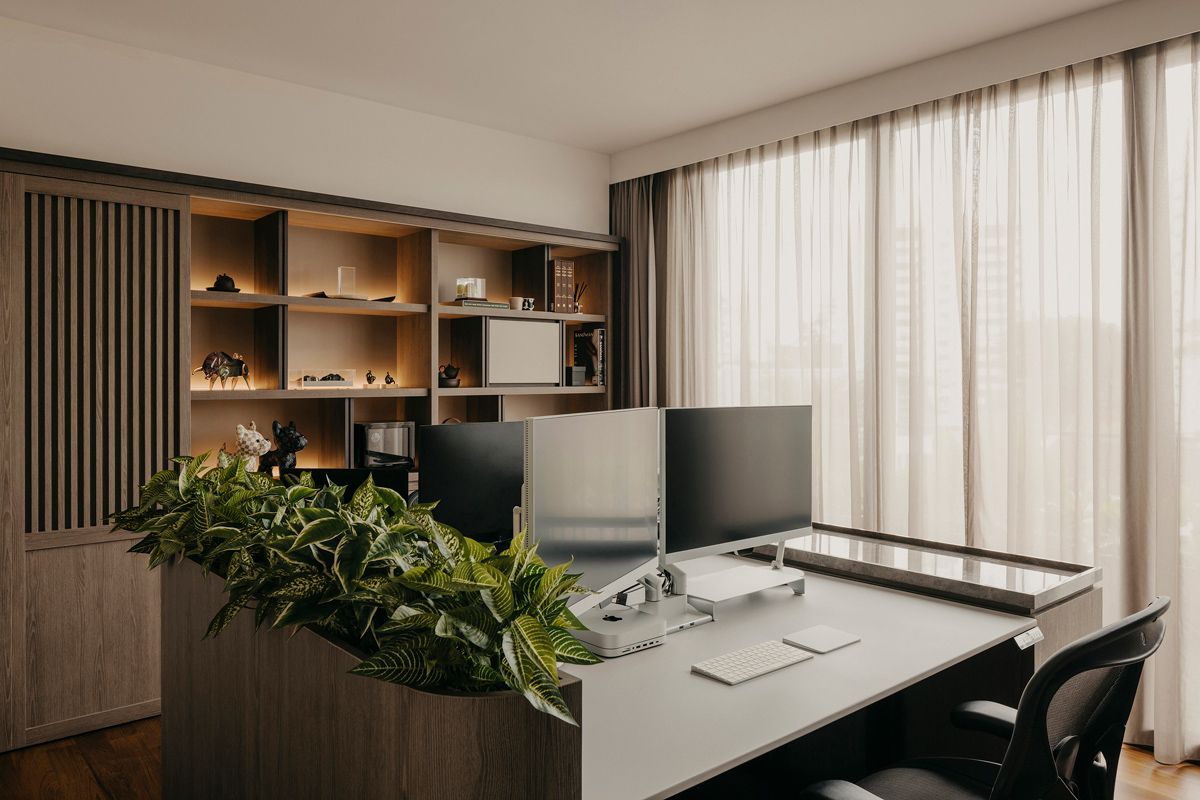 The handsome home office features plants that lend a biophilic touch