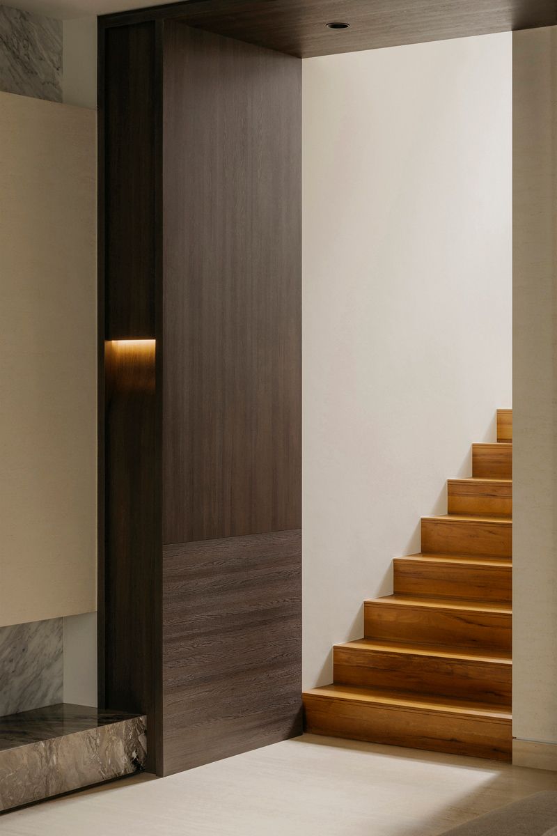 The warm-tones staircase makes for a golden accent in this corner
