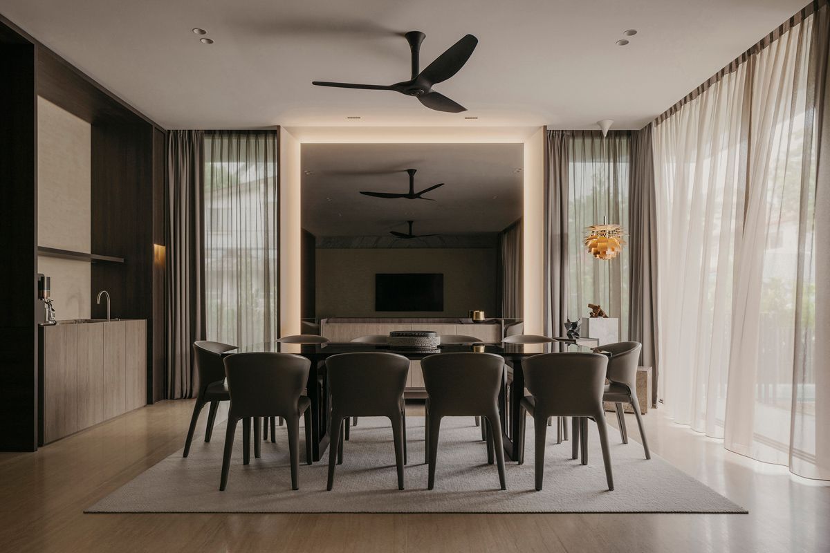 The dining room features a pleasing symmetry anchored by a mirrored wall that doubles the perception of the space