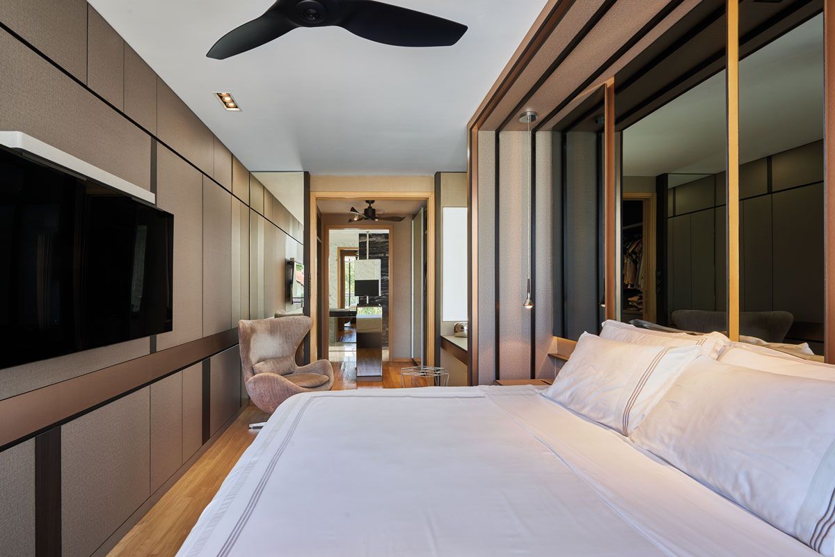 Tinted mirrors are employed to ensure privacy and add a touch of style to this home’s bedroom