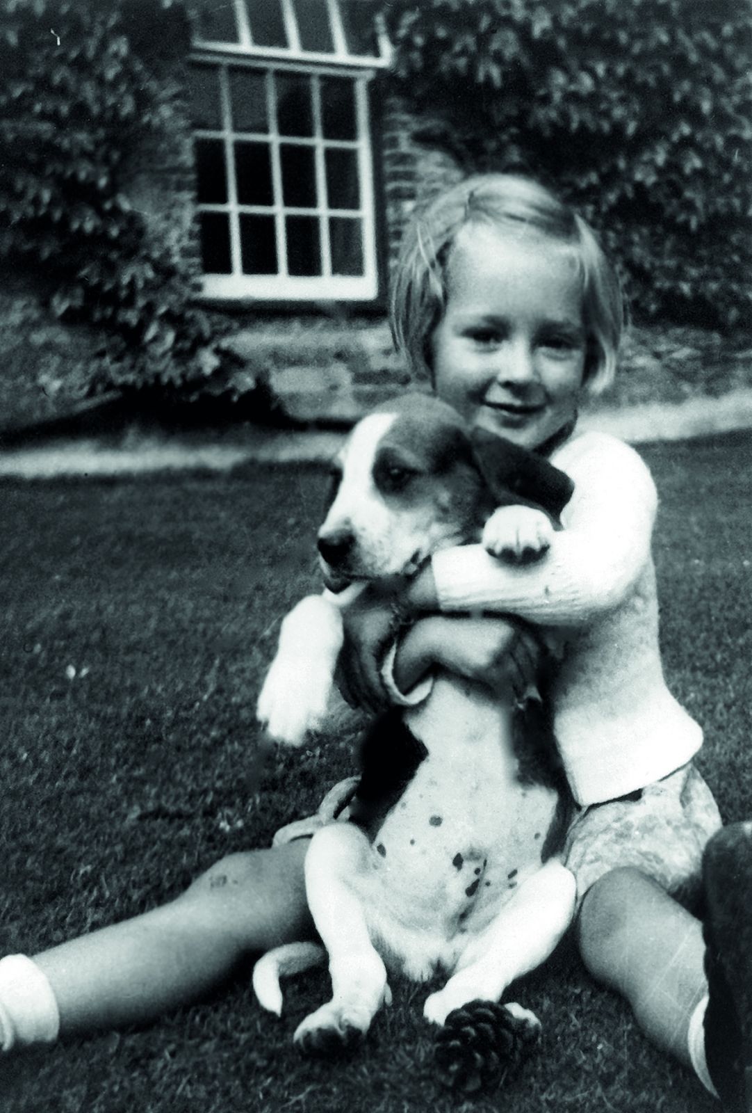 A lifelong animal lover, young Jane Goodall holds a puppy at her home, The Birches.