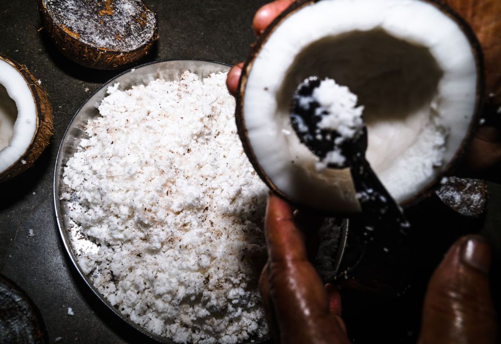 The extraction of coconut flesh, used in many traditional Malay dishes (Photo by Soumyabrata Roy/NurPhoto via Getty Images)