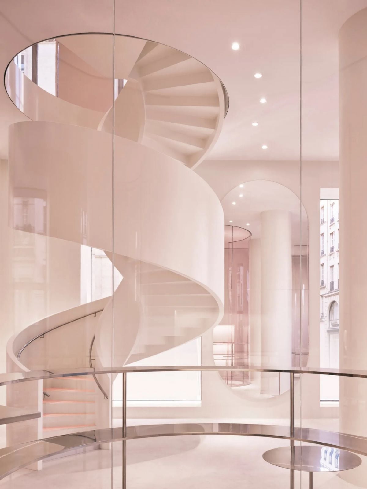 The signature spiral staircase serves as both functional element and sculptural centerpiece (Photo: Alaïa)