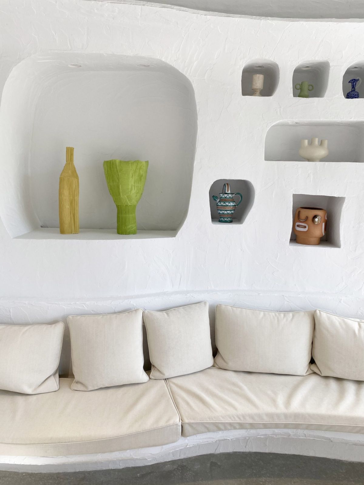A detail of Café Oursin's distinctive wall design shows the thoughtfully arranged display niches housing colorful artisanal ceramics (Photo: Jacquemus)