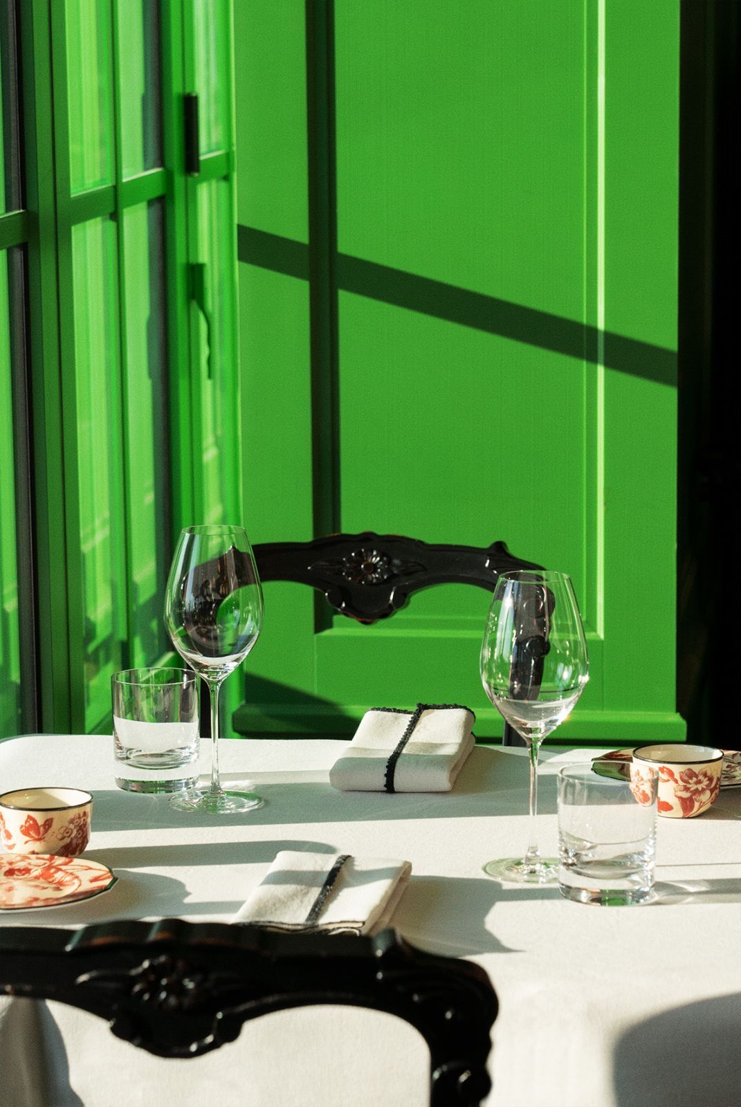Tables at Gucci Osteria Seoul feature tableware from Gucci’s Décor collection against the brand’s signature green walls (Photo: Gucci)