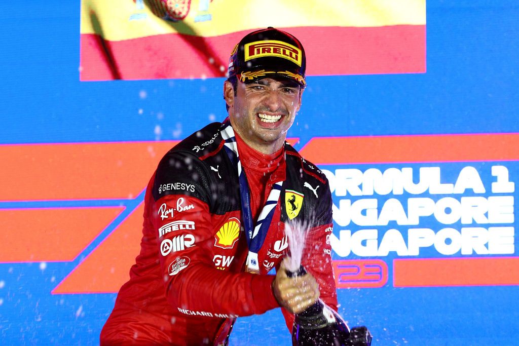 SINGAPORE, SINGAPORE - SEPTEMBER 17: Race winner Carlos Sainz of Spain and Ferrari celebrates on the podium during the F1 Grand Prix of Singapore at Marina Bay Street Circuit on September 17, 2023 in Singapore, Singapore. (Photo by Clive Rose/Getty Images)