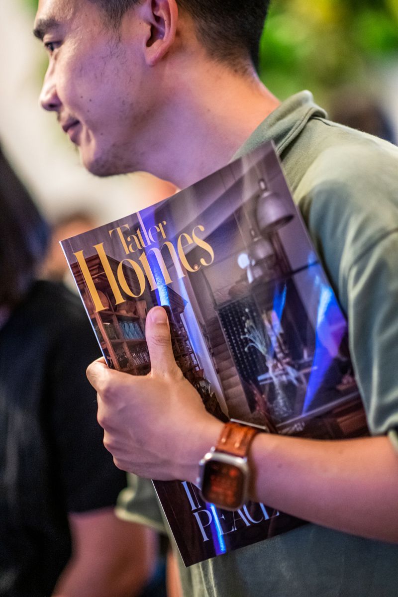 Kelvin Wang holding the latest issue of Tatler Homes Singapore