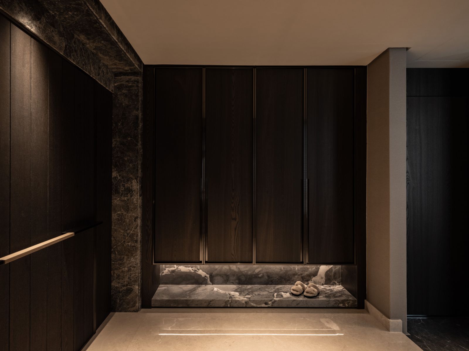The foyer serves as a calibrated introduction to the penthouse’s design language