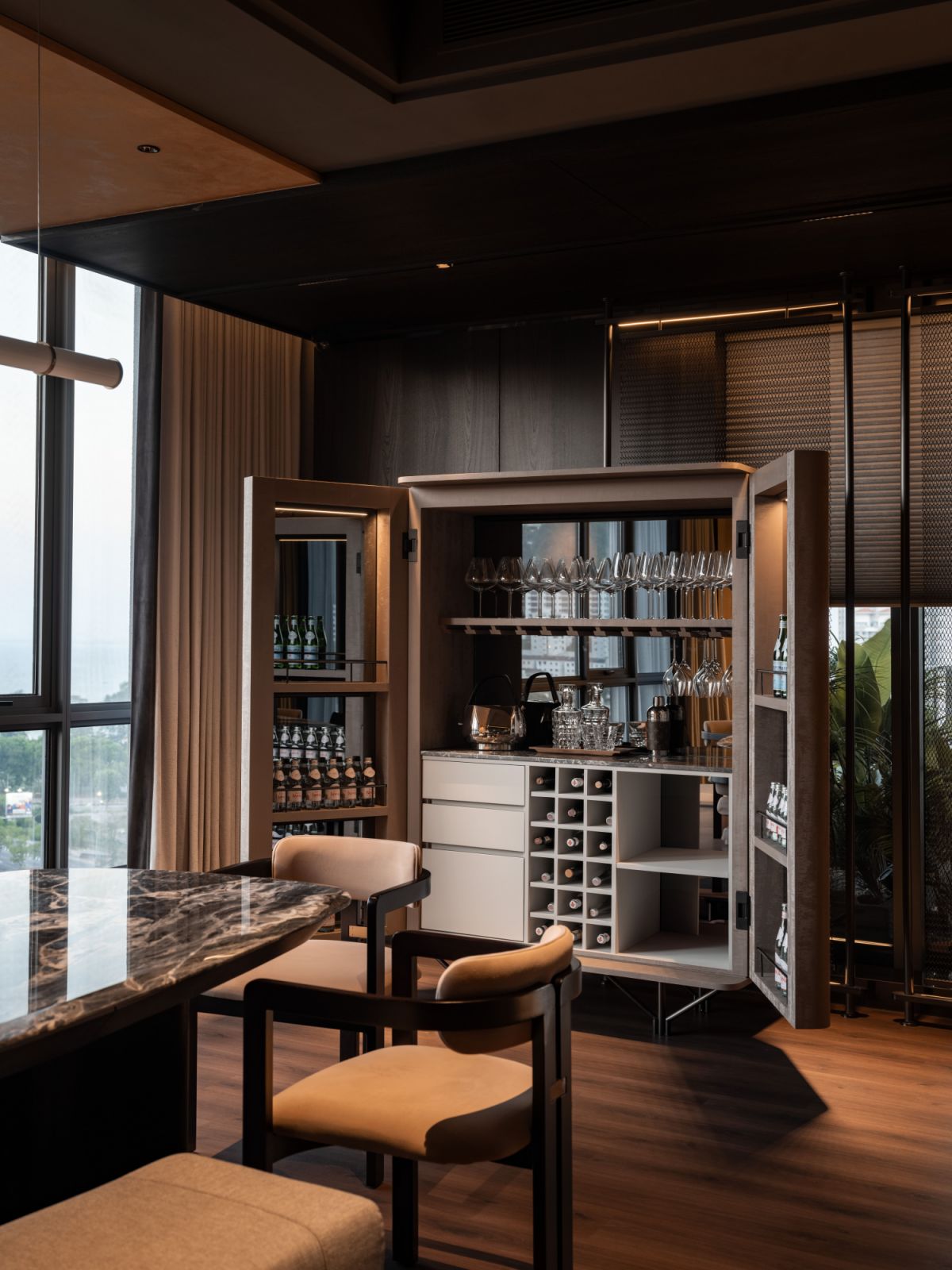 The open bar cabinet  has illuminated shelving displays curated spirits against reflective backing,