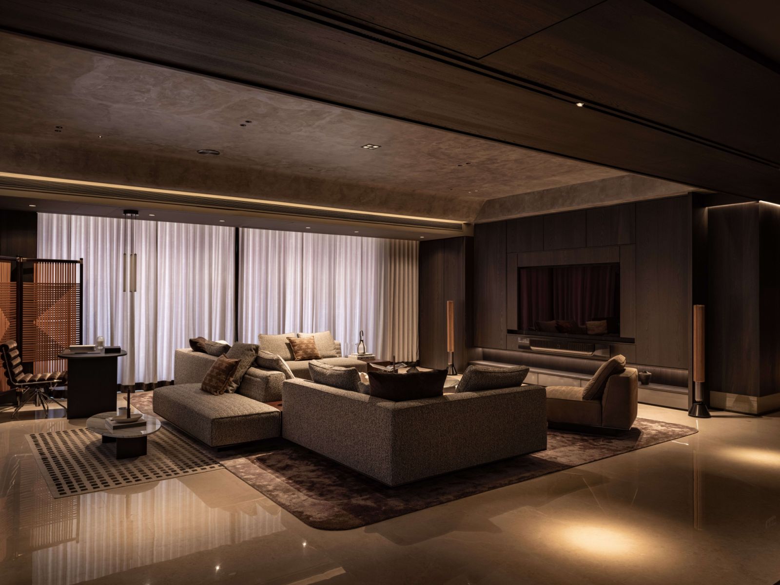 The Minotti Roger Set sofa anchors the living space, where steel chrome elements create visual tension against veneer paneling