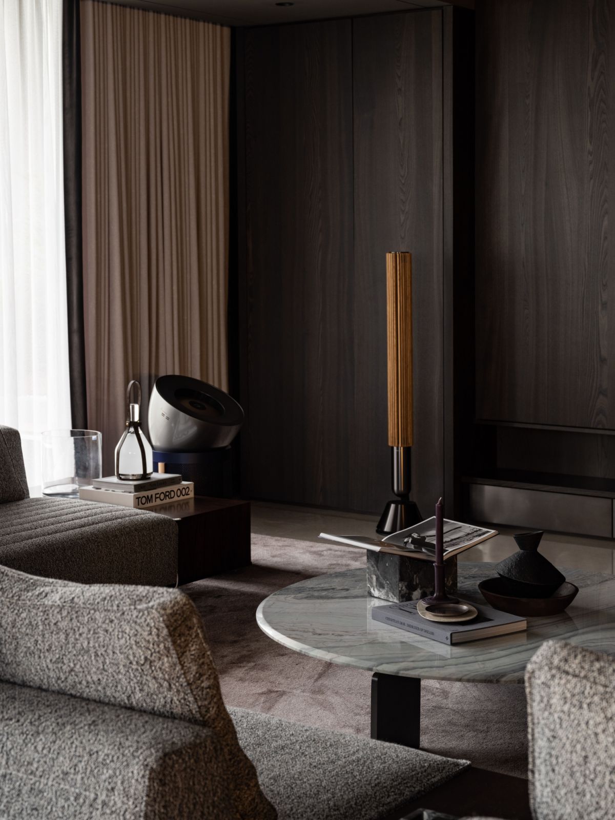 This detail of the living room highlights the material interplay that defines the penthouse's aesthetic