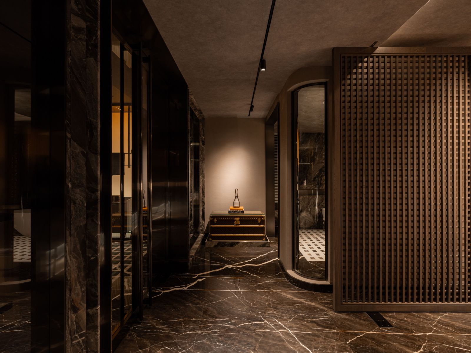 A Louis Vuitton trunk marks the entrance to the master bedroom