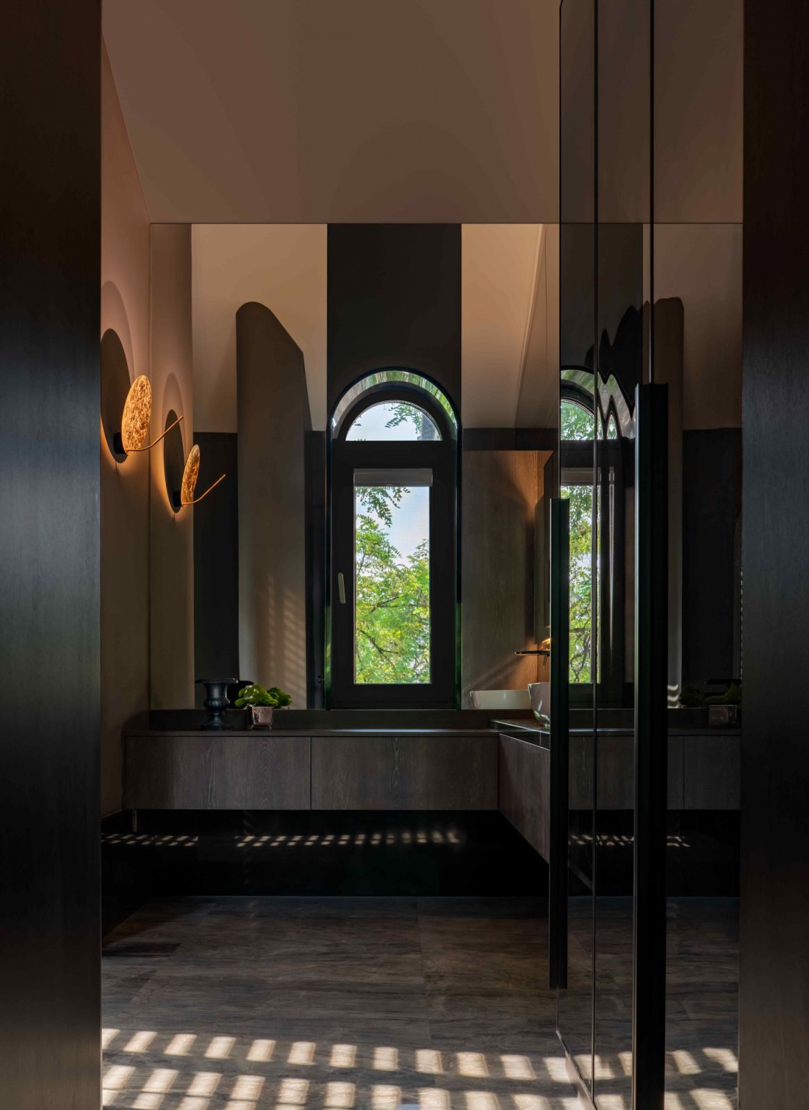 The master ensuite features dark wood and ambient lighting for a warm, luxurious mood