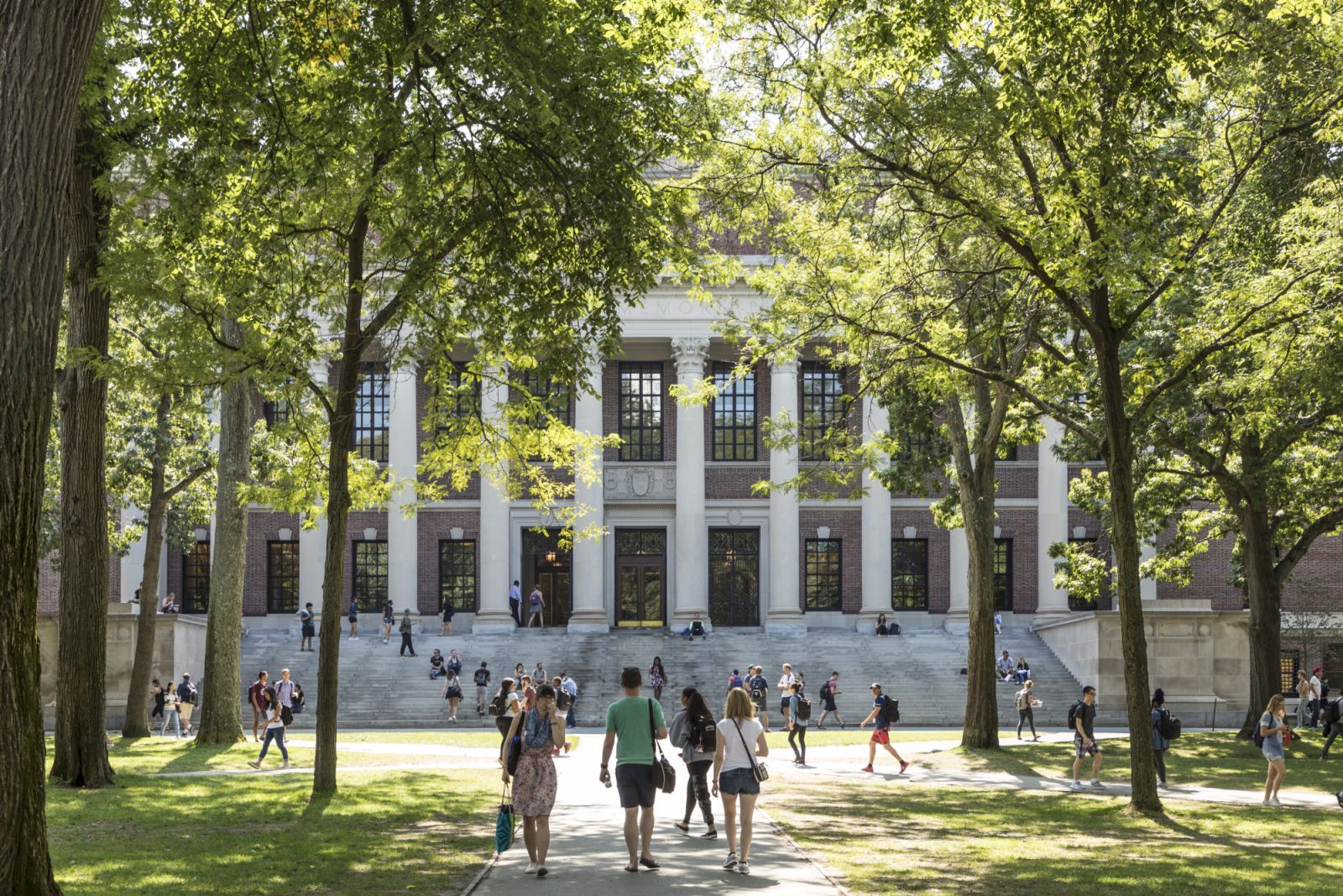 CAMBRIDGE, MA, USA - SEPTEMBER 13, 2017: Students and tourists rest in lawn chairs in Harvard Yard, the open old heart of Harvard University campus in Cambridge, MA, USA.