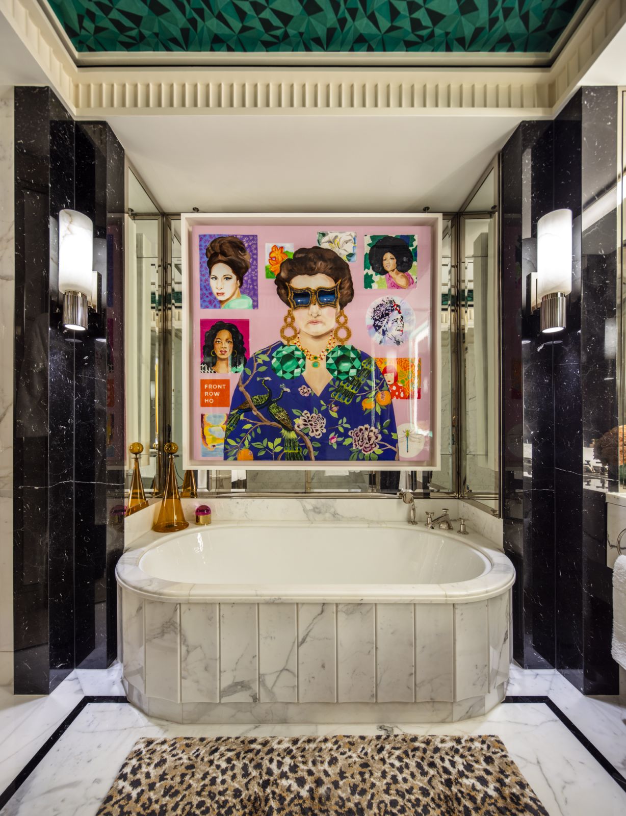 The master bathroom with sconces from Herve van der Straeten and the artwork “Peggy Guggenheim Portrait Commission” by Sarah Ashley Longshore in a Central Park, New York family home