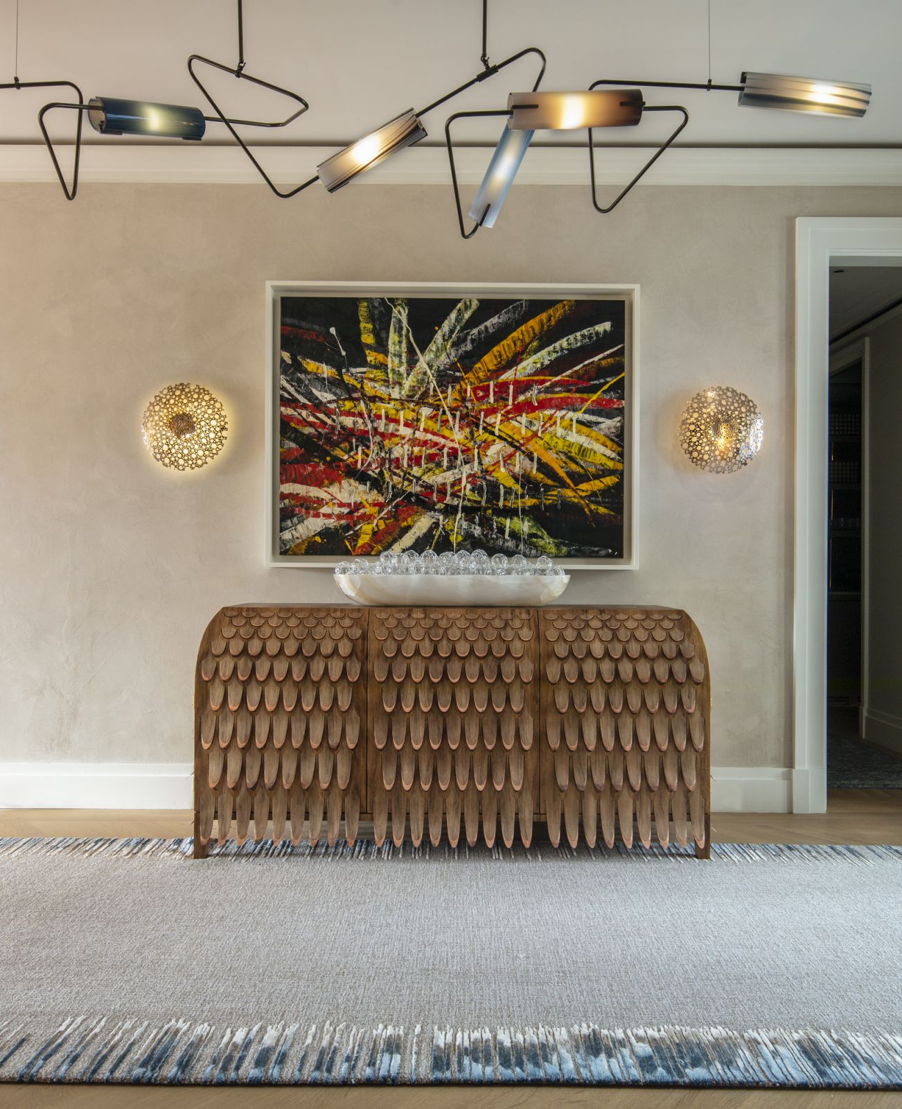The gallery in the entryway of a family home in Central Park, New York, with the Pankalangu Credenza by Trent Jansen via Gallery All and the artwork “Untitled (Capri 53, 18)” by Mark Grotjahn beneath a chandelier by Avram Rusu Studio