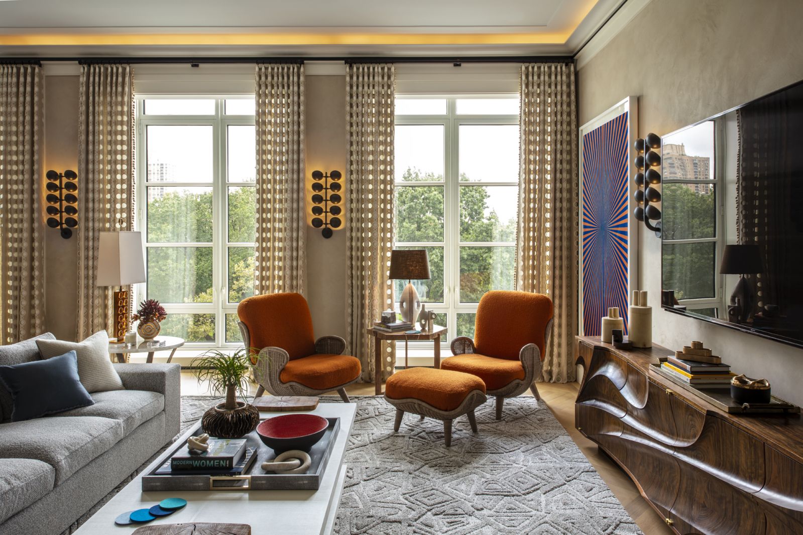 The grand room with Siesta Lounge Chairs by Mattia Bonetti via 21st Gallery, upholstered in Rosemary Hallgarten alpaca bouclé; also featured is the painting “Untitled (Orange and Copenhagen Blue Butterfly)” by Mark Grotjahn in a Central Park, New York family home