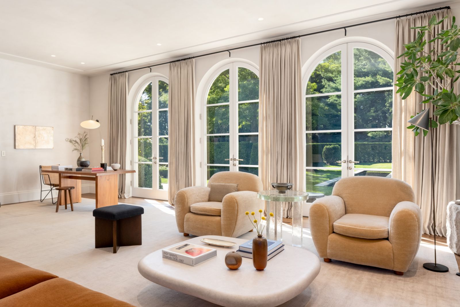 An intentional neutral palette to highlight the lush greenery through the glass-panelled French doors