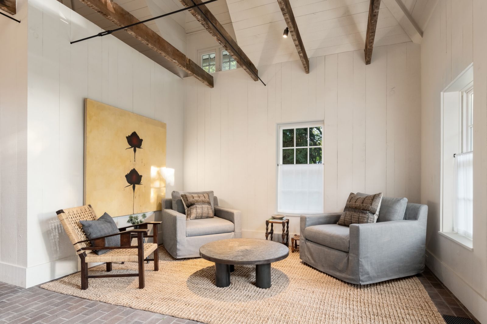 Vaulted wood-beamed ceilings in the minimalist living room corner