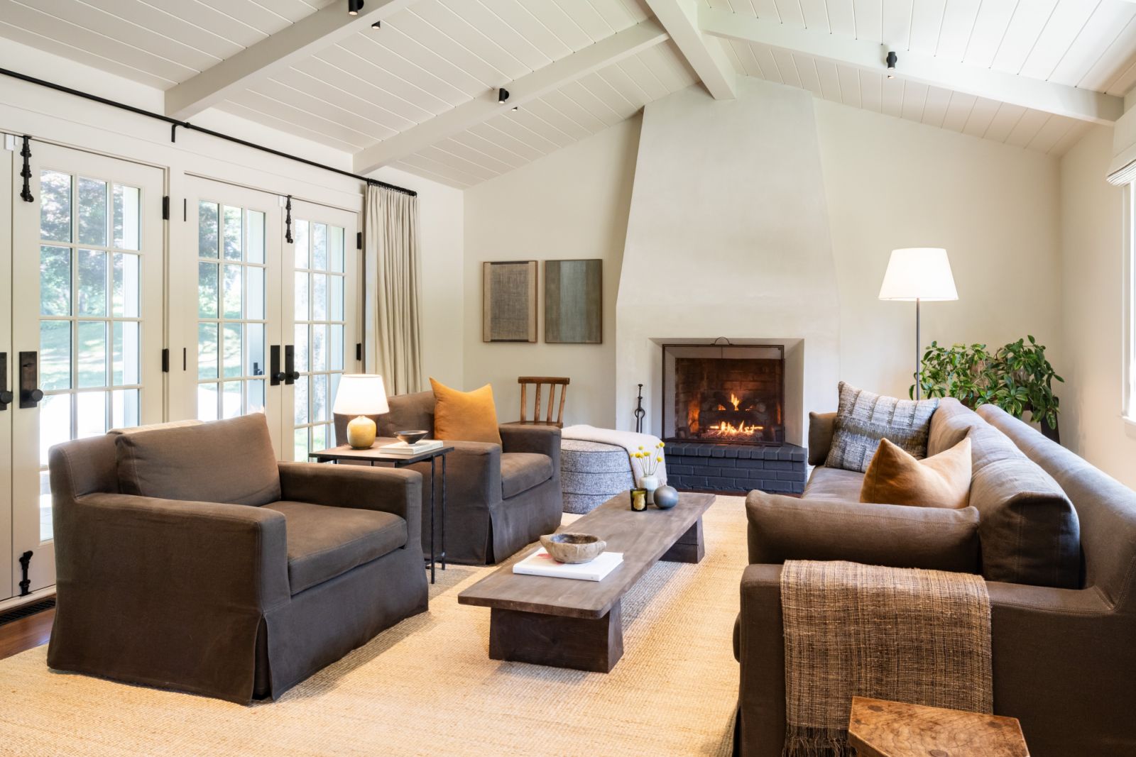 Vintage pieces reupholstered in contemporary textiles, layered alongside modern furnishings