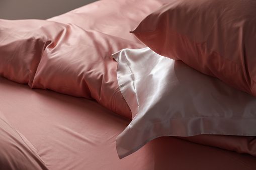 Use silk linens when you sleep to keep your curls intact throughout the night (Photo: Getty Images)