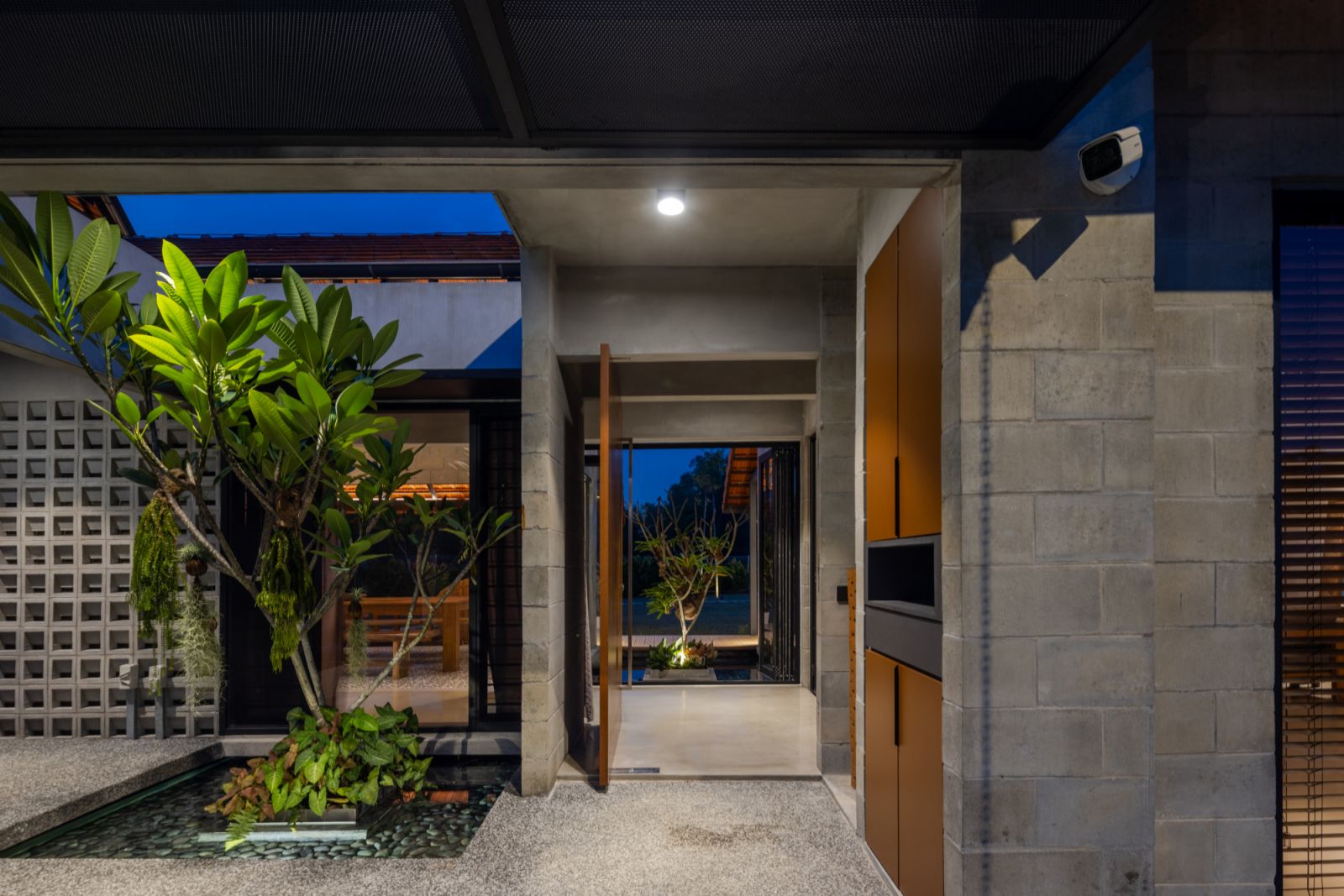 The concrete block walls and wooden doors remain unfinished, emphasising the raw material aesthetic