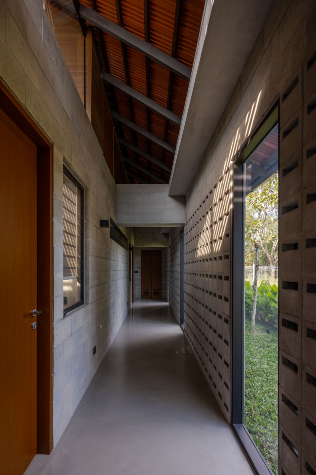 A corridor featuring the distinctive concrete vent block walls that provide natural ventilation throughout the home