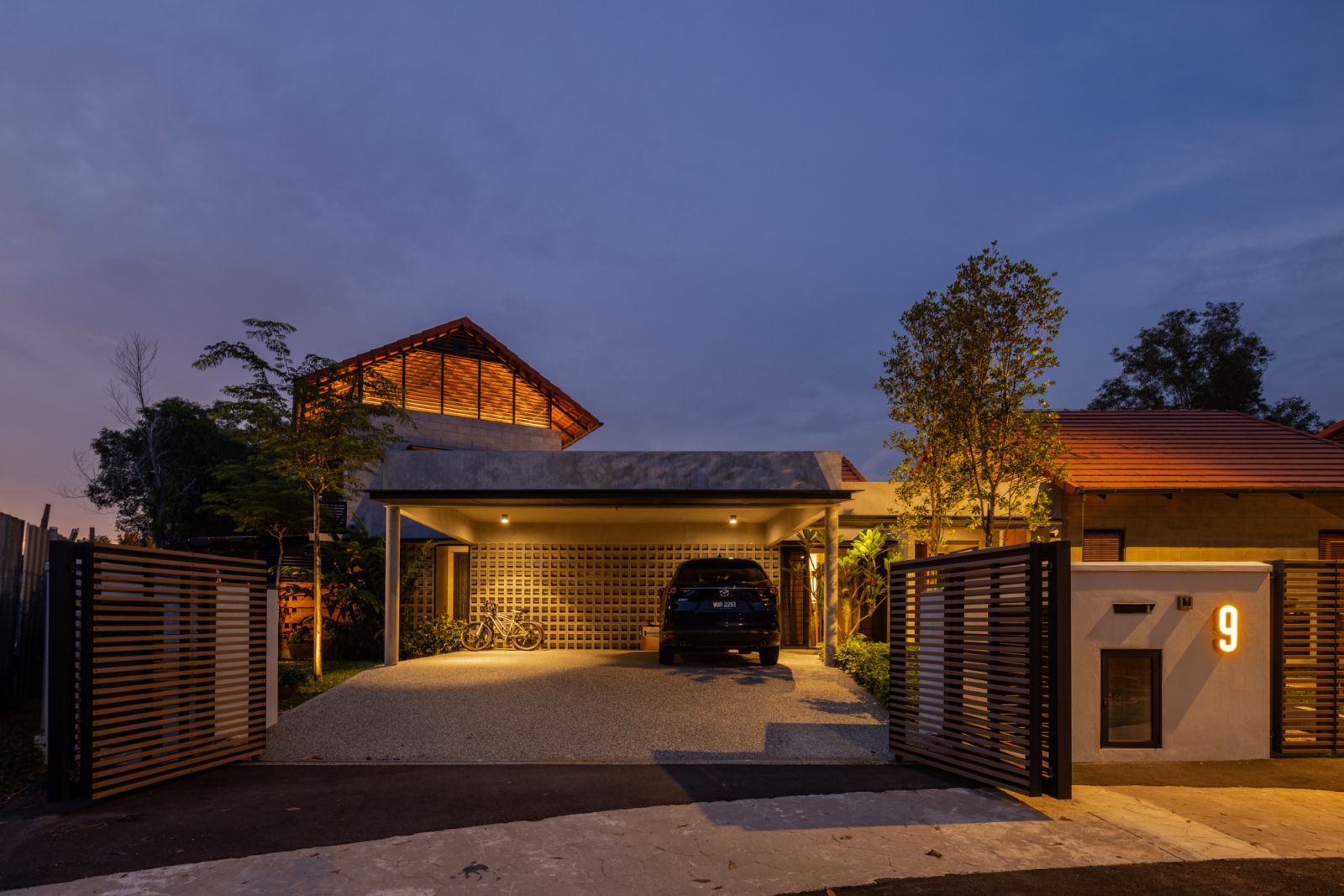 The structure “floats” approximately one foot above ground level, offering protection from outdoor elements while maintaining connection to the landscape