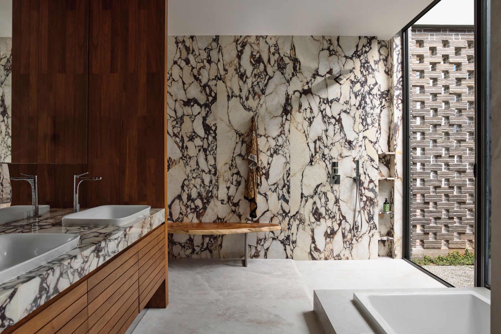 Dramatically veined Calacatta Viola marble lends a graphic touch to the junior master bathroom