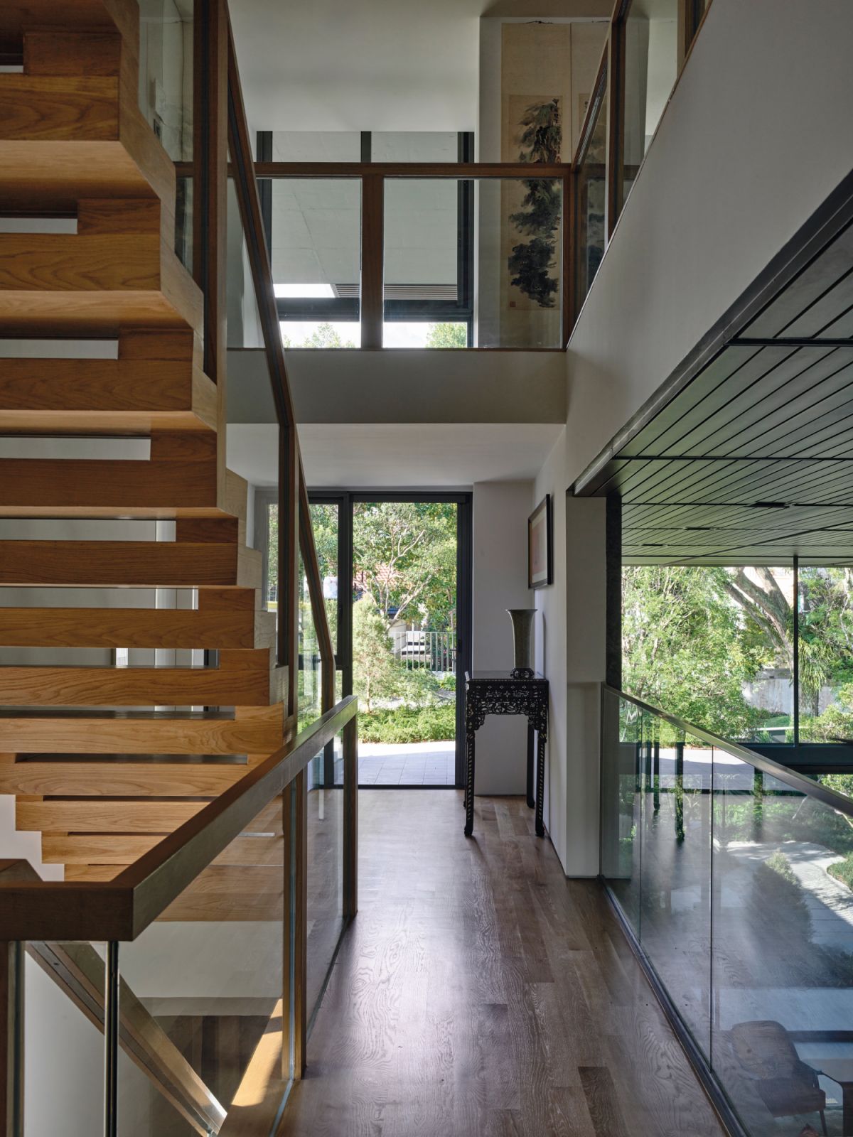 The staircase’s open risers amplify light and a sense of lightness, with the gaps small enough to ensure the safety of the couple’s pet dog