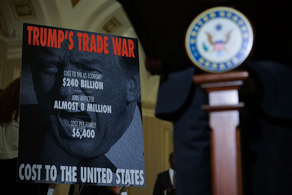 WASHINGTON, DC - APRIL 01: A sign on Trump's Trade War behind U.S. Tim Kaine (D-VA) while he speaks to reporters following the weekly Democratic Senate policy luncheon at the U.S. Capitol on April 01, 2025 in Washington, DC. Senators spoke about the White House's intended tariffs and taxes to be implemented. (Photo by Kayla Bartkowski/Getty Images)