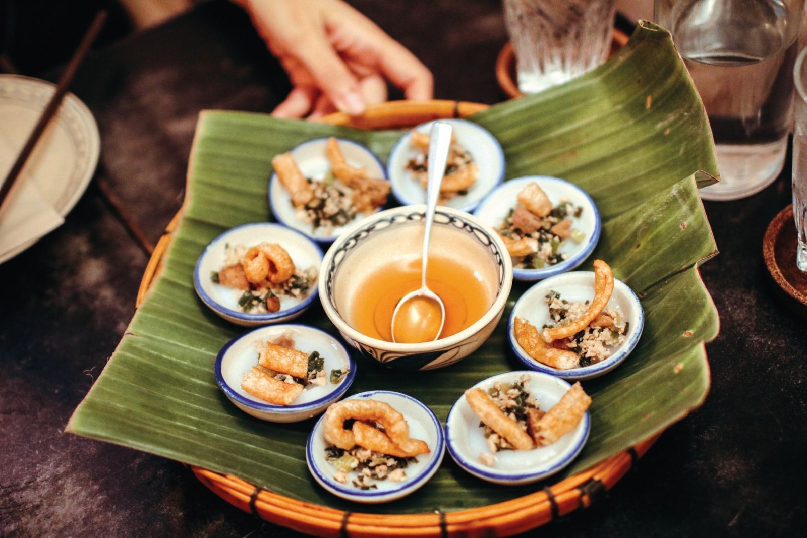 Banh Beo is vietnam food traditional VIETNAM food in mini dish rice pancake with local spice dried shrimp top served in bamboo basket tray with mild clear source and fresh green clean vegetable as app