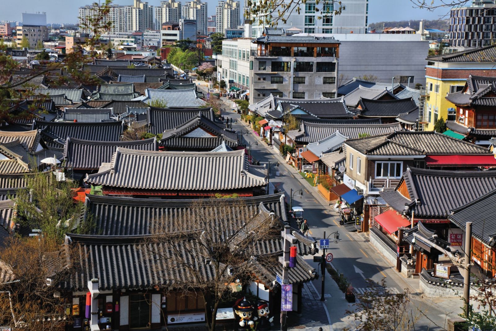 Tourists visit Jeonju Hanok Village, preserved district of traditional wooden houses.