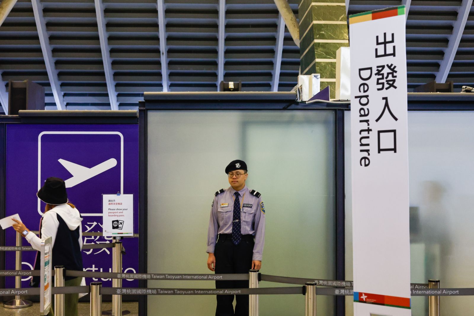 TAOYUAN, TAIWAN, JULY 24: A security guard stands guard as a passenger enters the restricted area for departure, as super typhoon Gaemi hitting the island disrupted international and domestic flights, at Taoyuan International Airport, on Taoyuan, Taiwan, 24 July 2024. Local Taiwanese media reported that more than 200 international flights and 261 domestic flights, including these bound for the United States, Japan, Vietnam, Australia, the Philippines and others have been cancelled or delayed, as the super t