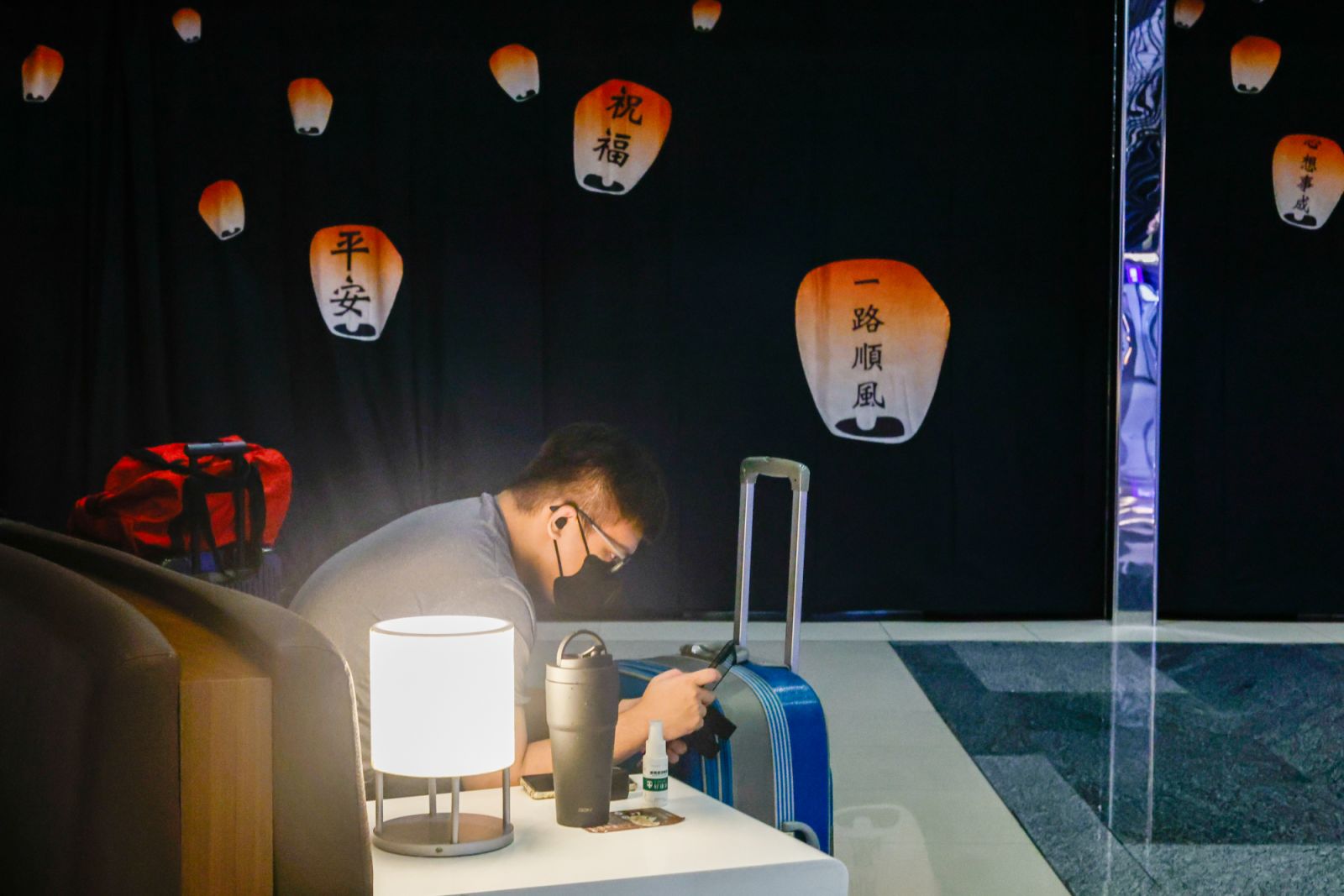 TAOYUAN, TAIWAN, JULY 24: A man departing for Japan sits on a sofa against the backdrop of an advertisement of the Taiwanese Sky Lanterns which signify safety and luck, after his flight was cancelled, as super typhoon Gaemi hitting the island disrupted international and domestic flights, at Taoyuan International Airport, on Taoyuan, Taiwan, 24 July 2024. Local Taiwanese media reported that more than 200 international flights and 261 domestic flights, including these bound for the United States, Japan, Vietn