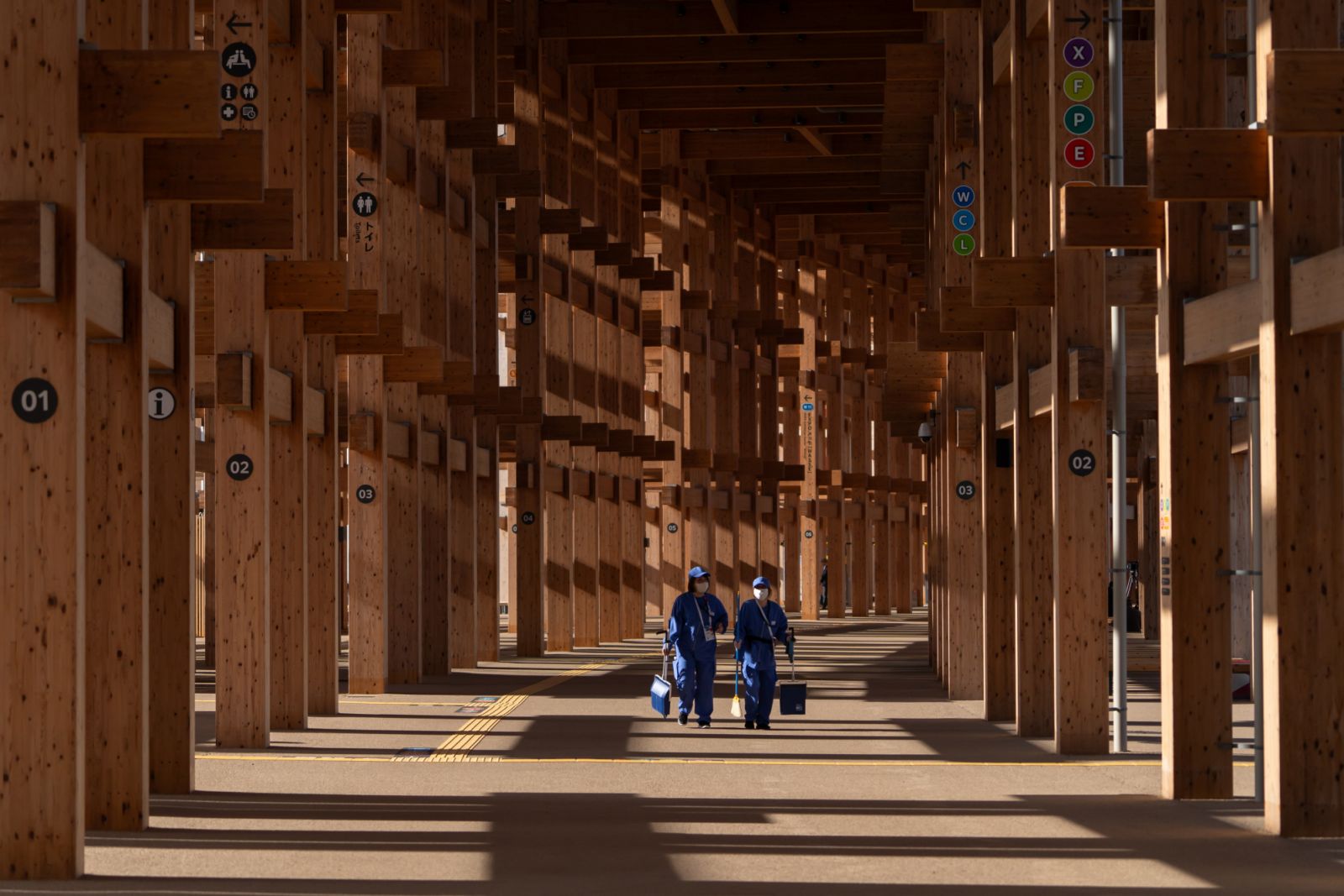 OSAKA, JAPAN - APRIL 09: Cleaners walk through the Grand Ring wooden structure during the media day held ahead of the Expo 2025 Osaka, Kansai, Japan on April 09, 2025 in Osaka, Japan. The World Expo 2025 in Osaka, Japan, is a significant global event themed "Designing Future Society for Our Lives," focusing on technological innovation and sustainable development. Against the backdrop of Trump's trade tariffs, the Expo serves as a platform for Japan to showcase its commitment to multilateral cooperation and