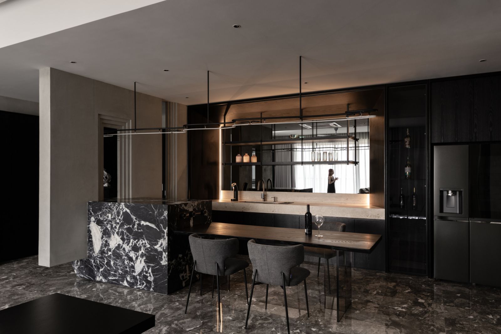 The dining zone employs subtle material transitions and careful lighting to maintain visual coherence