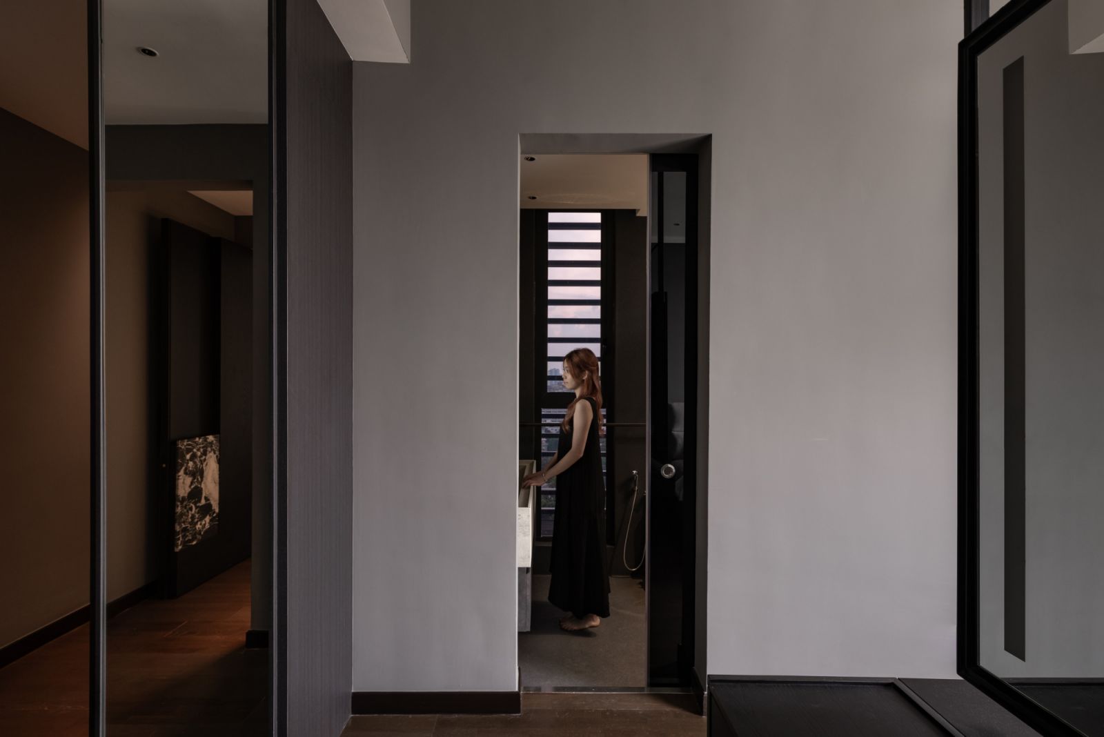 The threshold into the master bathroom continues the home’s artistic approach to transitions