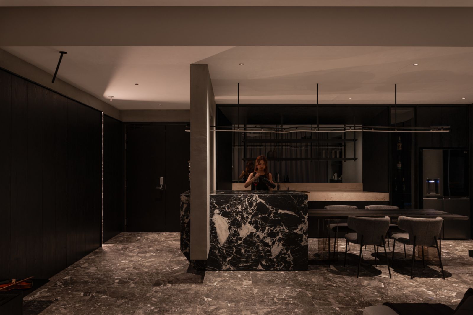 The integrated foyer divider and island eliminate conventional boundaries