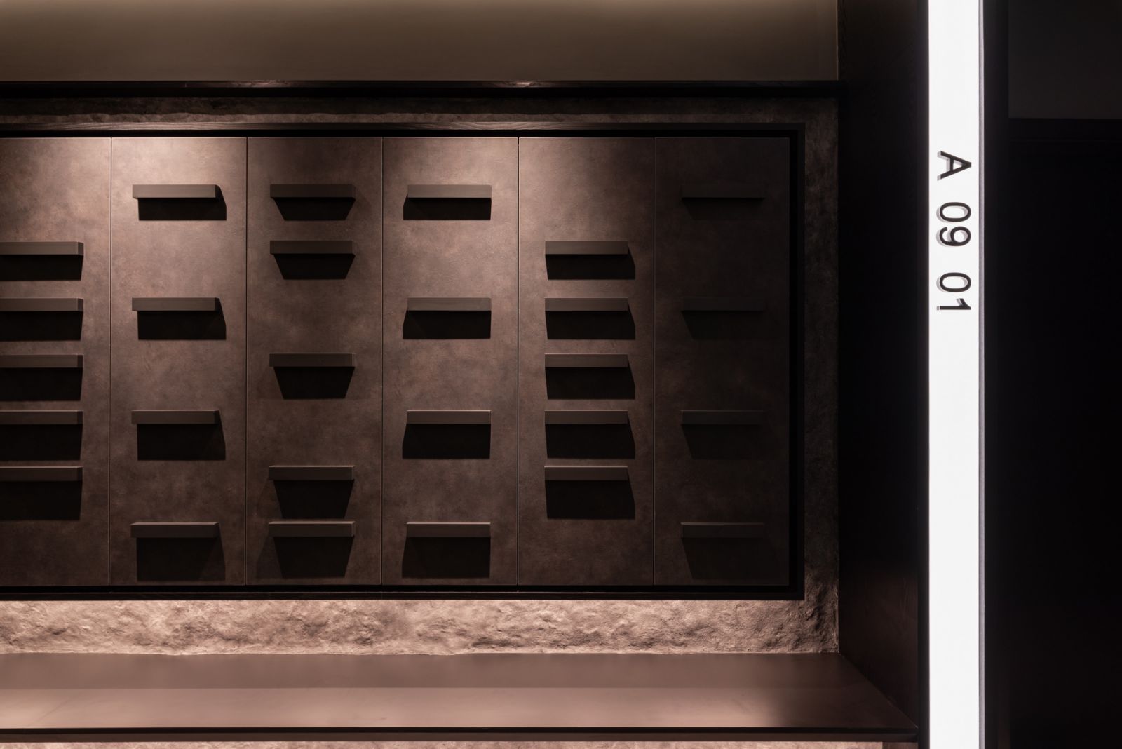 The entrance experience immediately establishes the home’s nocturnal identity